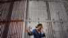 Mexico -- A worshiper participates in a Mass along the U.S.-Mexico border wall on February 22, 2015