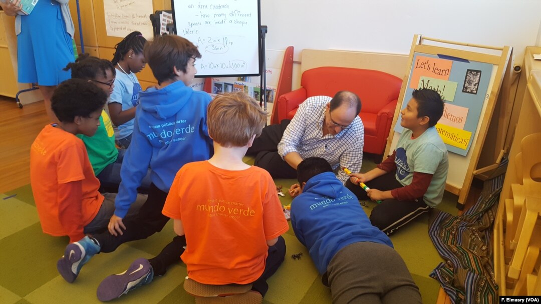 Students at Mundo Verde bi-lingual school work on solving a mystery with teacher David Levin.