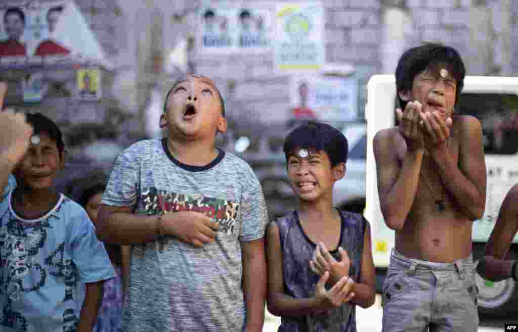 Boys take part in a game during the yearly Feast Day of St. Rita of Cascia in Manila, Philippines, May 19, 2019.