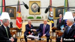 U.S. President Donald Trump shakes hands with U.S. Representative Jeff Van Drew, a Democratic lawmaker who opposed his party's move to impeach Trump, in the Oval Office of the White House in Washington, Dec. 19, 2019.