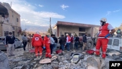 Rescuers check the destruction at the site of an Israeli airstrike that targeted the eastern village of Bazzaliyeh in the Hermel district of Lebanon's Bekaa valley, on Nov. 1, 2024.