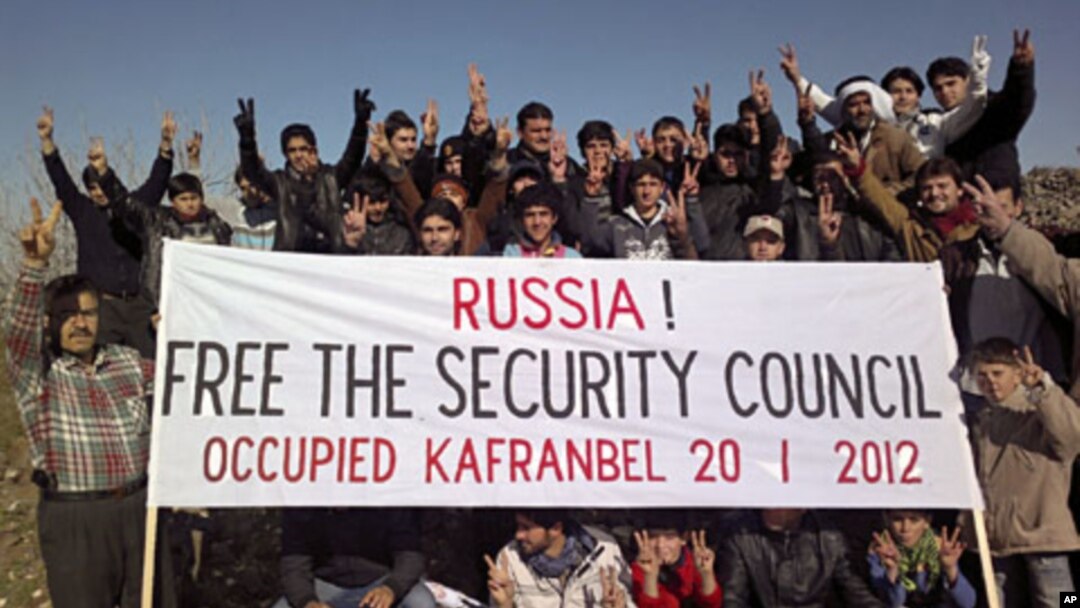 Demonstrators gather during a protest against Syria's President Bashar al-Assad and Russia in Kafranbel near Idlib, January 20, 2012