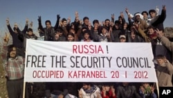 Demonstrators gather during a protest against Syria's President Bashar al-Assad and Russia in Kafranbel near Idlib, January 20, 2012