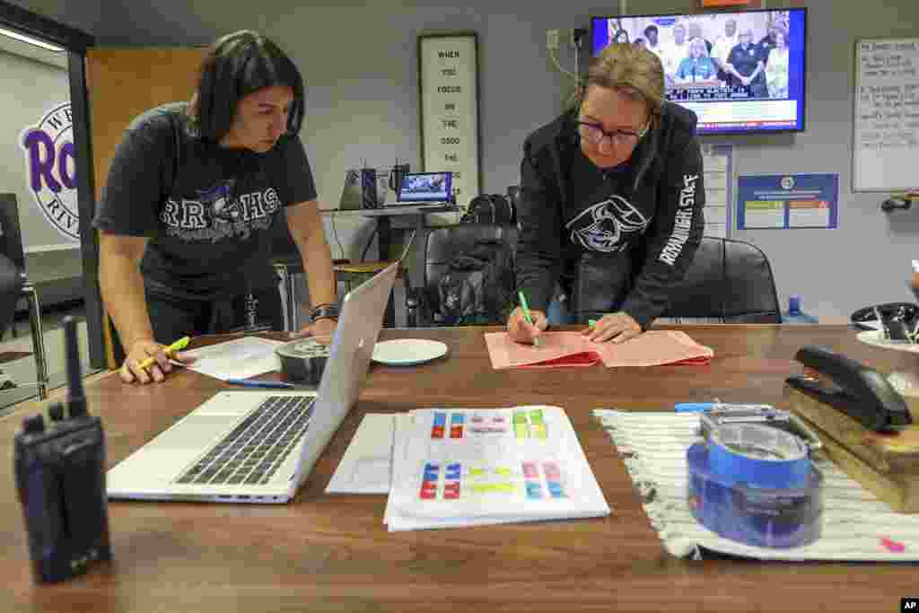 River Ridge High School staff members Ellie Papapanos, left, and Anne Donlon go over preparations as they ready the school for use as a shelter in preparation for Hurricane Milton, Oct. 7, 2024, in New Port Richey, Florida.