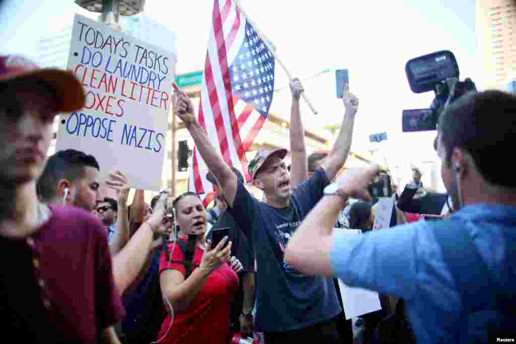 Pro Trump supporters face off with peace activists during protests outside a Donald Trump campaign rally in Phoenix, Ariz., Aug. 22, 2017.