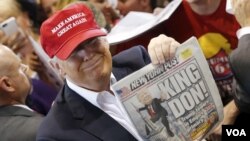 Donald Trump holds up the front page of the New York Post in Harrington, Delaware, April 22, 2016. The Post called him "King Don" after his New York primary victory, but it had predicted his candidacy's demise in a July 2015 headline. 