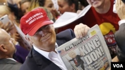 Republican presidential candidate Donald Trump holds up the front page of the New York Post as he signs autographs in Harrington, Delaware, April 22, 2016. The Post called him "King Don" after his New York primary victory, but it had predicted his candida