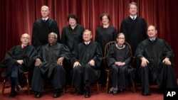 The justices of the U.S. Supreme Court gather for a formal group portrait at the Supreme Court Building in Washington, Nov. 30, 2018.