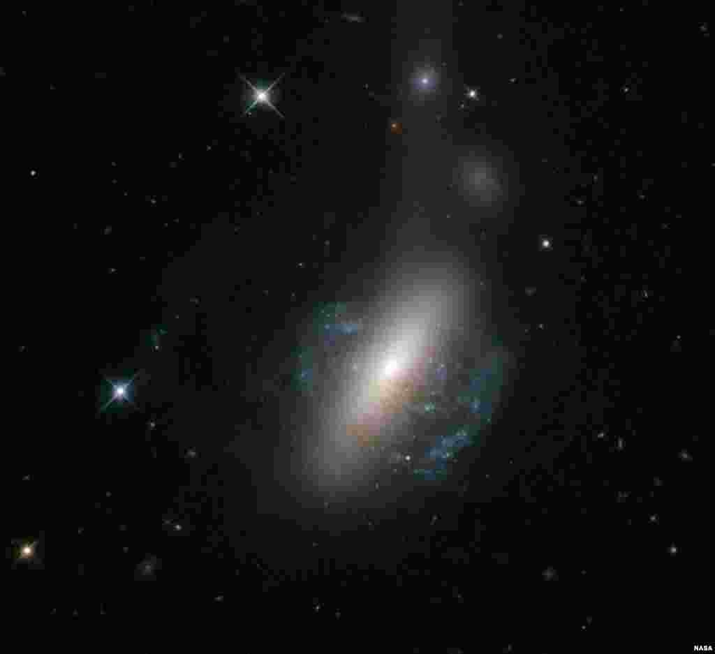 The NASA/ESA Hubble Space Telescope captures an ongoing cosmic collision between two galaxies - a spiral galaxy is in the process of colliding with a lenticular galaxy. (European Space Agency/NASA Hubble)