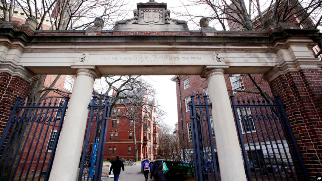 FILE - People walk through the gates leading to Harvard Yard, at Harvard University in Cambridge, Massachusetts, Dec. 13, 2018.