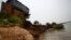 FILE - The remnants of a house built on the Mekong river banks is pictured after a portion of it collapsed when the soil underneath gave way, in Kandal province.
