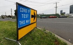 A sign leading to a COVID-19 testing station in Melbourne, Australia, Feb. 4, 2021.