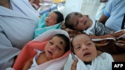 Indian nurses care for newborn babies at the maternity ward of a hospital in Guwahati on the eve of World Population Day, July 10, 2014.