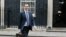 FILE - Britain's Chancellor George Osborne walks across Downing Street on his way to attend a press conference at the Foreign Office with Christine Lagarde of the International Monetary Fund, in London, May 13, 2016. 