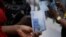 FILE - A person holds a new 1000 Naira note as the Central Bank of Nigeria releases the notes to the public through the banks in Abuja, Nigeria, Dec. 15, 2022. 