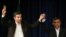Iranian President Mahmoud Ahmadinejad, right, joins hands with his close ally Esfandiar Rahim Mashaei, as he flashes a victory sign, at the start of a press conference, May 11, 2013.