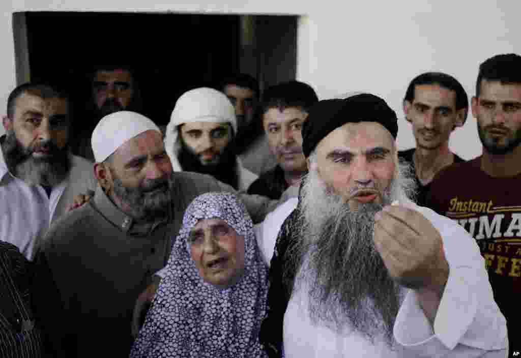 Abu Qatada stands with his mother Aisha as he speaks to the media from his parents&#39; home in Amman, Jordan, Sept. 24, 2014. 