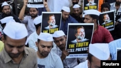 Supporters of the Youth Congress Party hold placards during a silent protest against the conviction of Rahul Gandhi, senior party leader of India's main opposition Congress party, in a 2019 Defamation case by a Surat court, on a street in Mumbai, India, March 23, 2023.