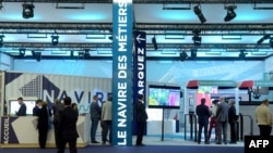 FILE - People visit the Navire des Metiers stand at Euronaval 2018, a naval defense equipment fair, in Le Bourget, near Paris, Oct. 23, 2018. 