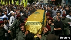 Supporters of Hezbollah and relatives of Hezbollah member Hussein Ahmad Abu Hasan carry his coffin during his funeral in Beirut's suburbs May 21, 2013.