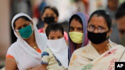 People wait in line at a coronavirus testing site in Prayagraj, India, Sept. 5, 2020. 