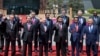 Chinese President Xi Jinping, front row third right, waves with leaders attending the Belt and Road Forum as they pose for a group photo at the Yanqi Lake venue on the outskirt of Beijing, China, Monday, May 15, 2017. They are, front row from left, Turkish President Recep Tayyip Erdogan, Vietnamese President Tran Dai Quang, Russian President Vladimir Putin, Xi, Indonesian President Joko "Jokowi" Widodo and Kazakhstan President Nursultan Nazarbayev, and second row from third left to right, Hungarian Prime Minister Viktor Orban, Cambodian Prime Minister Hun Sen, Spanish Prime Minister Mariano Rajoy, Malaysian Prime Minister Najib Razak and Ethiopian Prime Minister Hailemariam Desalegn. (AP Photo/Ng Han Guan, Pool)