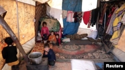 Internally displaced Syrian children from Idlib, are seen inside a tent in Azaz, Syria, Feb. 22, 2020.