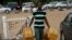 A man carries empty containers to buy fuel at a gas station in Abuja, Nigeria, May 26, 2015. 