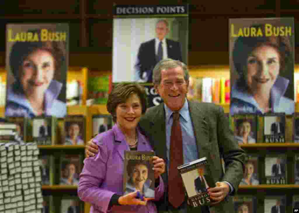 Former President George W. Bush, right, and his wife Laura appear together to sign their respective books,  'Decision Points' by him, ,and "Spoken From the Heart'" by her, Thursday, Dec. 16 in Atlanta.