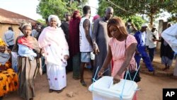 FILE - People line up to cast their ballots in Guinea-Bissau's legislative elections in Bissau Sunday June 4, 2023.