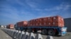 FILE - Trucks loaded with aid wait to cross into Gaza from the Egyptian side of the Rafah border crossing on Jan. 19, 2025.