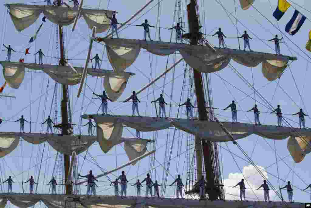 Mexican Navy crew stand on the sails of the ARM Cuauhtemoc sailing ship as it prepares to dock in the South Harbor for a five-day goodwill visit.