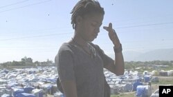 A resident leaves a camp for victims affected by the January 12 earthquake in Port-au-Prince, 11 Jul 2010