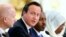 Britain's Prime Minister David Cameron speaks as Britain's Foreign Secretary William Hague, left, and Somali President Hassan Sheikh Mohamud listen at the Somalia conference in London, May 7, 2013.
