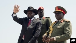 FILE - South Sudan's President Salva Kiir, accompanied by then-Army Chief of Staff Paul Malong, waves during an independence day ceremony in Juba, South Sudan, July 9, 2015. 