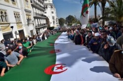 FILE - Algerian anti-government protesters take the streets as the Hirak pro-democracy movement keeps up its weekly demonstrations despite a ban on gatherings due to the coronavirus pandemic, in Algiers, March 26, 2021.