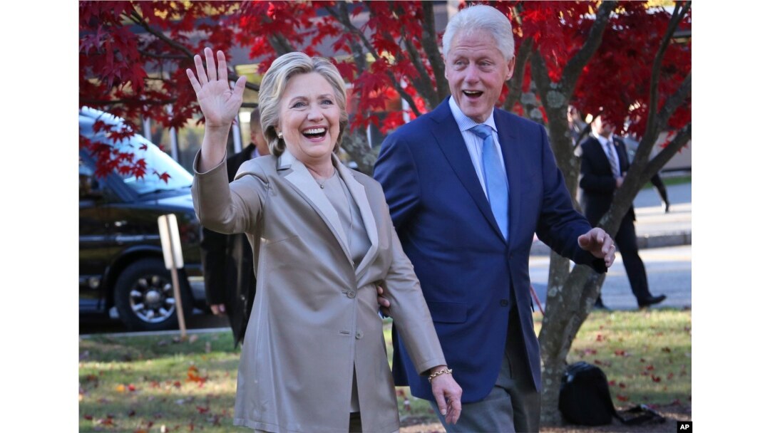 FILE - Former Democratic presidential candidate Hillary Clinton, and her husband former President Bill Clinton greet supporters in Chappaqua, N.Y., Nov. 8, 2016.