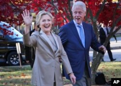 FILE - Former Democratic presidential candidate Hillary Clinton, and her husband former President Bill Clinton greet supporters in Chappaqua, N.Y., Nov. 8, 2016.
