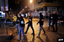 This picture taken on November 22, 2013 shows members of Bulgarian nationalist organizations patrolling the centre of Sofia. AFP