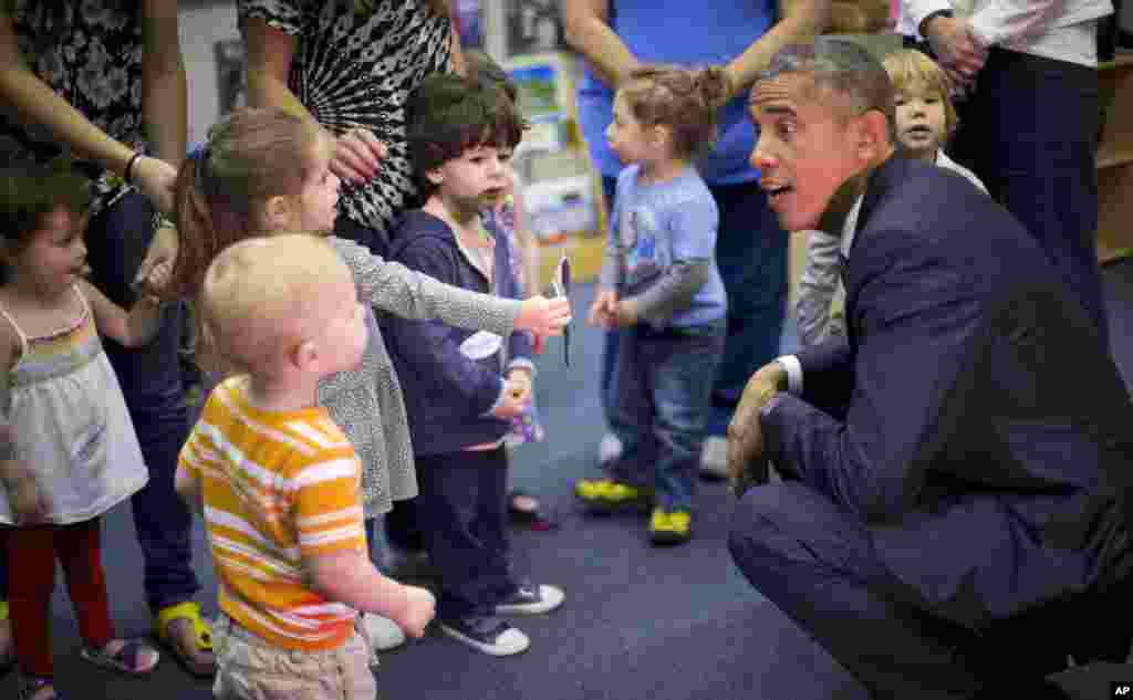 President Barack Obama talks with children during his visit to Gan HaYeled PreSchool at Adas Israel Congregation in Washington, May 22, 2015.