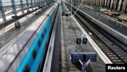 FILE - A TGV high-speed train operated by state-owned railway company SNCF speeds through the railway station in Bordeaux, France, Oct. 28, 2019.