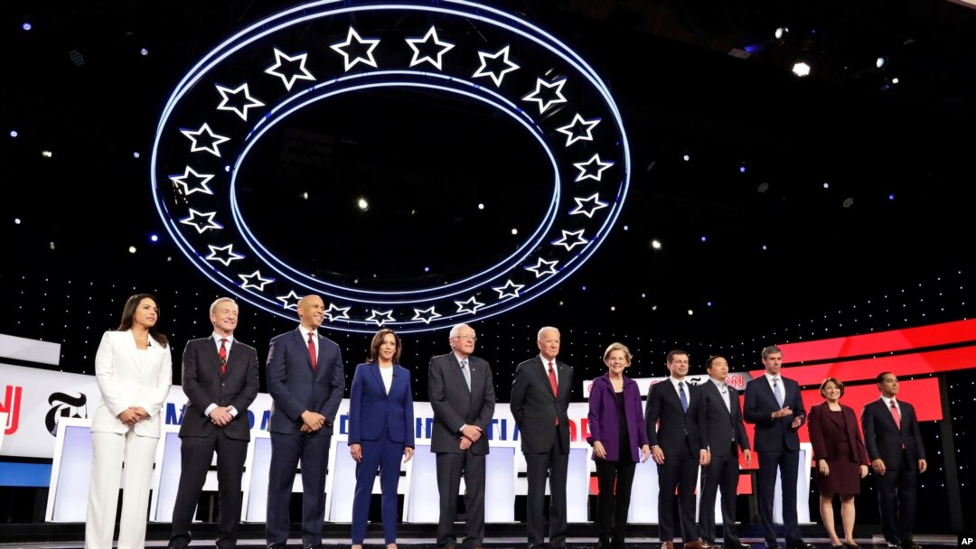 From left, Tulsi Gabbard, Tom Steyer, Cory Booker, Kamala Harris, Bernie Sanders, Joe Biden, Elizabeth Warren, Pete Buttigieg, Andrew Yang, Beto O'Rourke, Amy Klobuchar and Julian Castro are pictured before debating in Westerville, Ohio, Oct. 15, 2019.