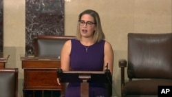 In this image from Senate Television, Sen. Kyrsten Sinema, D-Ariz., speaks on the floor of the U.S. Senate on Jan. 13, 2022. 