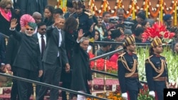 U.S. President Barack Obama, Indian Prime Minister Narendra Modi, left, and President Pranab Mukherjee wave to the crowd at the end of India’s annual Republic Day parade in New Delhi, India, Monday, Jan. 26, 2015. (AP Photo/Manish Swarup)