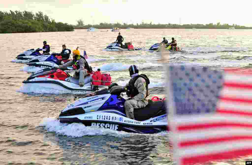 In this photo released by the Florida Keys News Bureau, combat veterans, aboard personal watercraft, leave Key West, Florida, USA, headed to New York City for a planned arrival on September 11. The approximately 1,600-mile (2,575-km) Never Quit Challenge voyage is to benefit three charities that assist military members, veterans and their families.