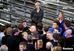 Britain's Prime Minister Theresa May visits a door manufacturer in Leeds, May 9, 2017.