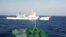 FILE - A ship, top, of the Chinese Coast Guard is seen near a ship of the Vietnam Marine Guard in the South China Sea, about 210 km (130 miles) off shore of Vietnam, May 14, 2014.