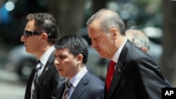 Turkish Prime Minister Recep Tayyip Erdogan, right, arrives for a cabinet meeting in his office in Ankara, Turkey, June 25, 2012.