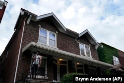 A man stands outside of the home of Craig Elazer in St. Louis on Friday, May 21, 2021.