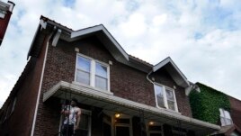 A man stands outside of the home of Craig Elazer in St. Louis on Friday, May 21, 2021.